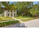 Charming home with a well-manicured lawn and mature trees providing shade at 7125 6Th N Ave, St Petersburg, FL 33710