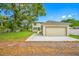 Beautiful home with a two-car garage, lawn, and mature trees at 7125 6Th N Ave, St Petersburg, FL 33710