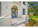 Inviting front porch with stucco detail and a stylish glass-paneled front door at 7125 6Th N Ave, St Petersburg, FL 33710