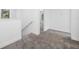 Upstairs hallway with carpet, a view of a bright room, and white walls and trim at 7125 6Th N Ave, St Petersburg, FL 33710