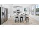 Bright kitchen featuring white cabinetry, an island with bar seating, and stainless steel appliances at 7125 6Th N Ave, St Petersburg, FL 33710