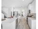 Modern kitchen with white cabinets, stainless appliances, and wood-look tile flooring at 7125 6Th N Ave, St Petersburg, FL 33710