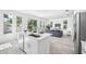Open kitchen with a large island and view into the living room and backyard at 7125 6Th N Ave, St Petersburg, FL 33710