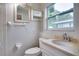 A bathroom with a granite countertop vanity, a toilet, a medicine cabinet, and a towel rack at 8275 32Nd N Ave, St Petersburg, FL 33710