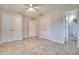 Neutral bedroom with tile floors, ceiling fan, and en-suite bathroom access at 8275 32Nd N Ave, St Petersburg, FL 33710