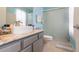 A renovated bathroom with granite countertop, an updated sink, cabinet hardware and a glass enclosed shower at 10011 Tranquility Way, Tampa, FL 33625