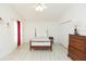 Bedroom with bright white walls, wood-look floors, ceiling fan and ample closet space at 10011 Tranquility Way, Tampa, FL 33625