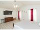 Spacious bedroom featuring a ceiling fan, wood floors, and a large dresser with a flatscreen TV above at 10011 Tranquility Way, Tampa, FL 33625