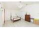 A bedroom features wood-look floors, ceiling fan, closet space, and a neutral color palette at 10011 Tranquility Way, Tampa, FL 33625