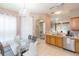 Dining area featuring a modern glass table and a chandelier, flowing into the kitchen at 10011 Tranquility Way, Tampa, FL 33625