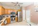 Well-lit kitchen featuring stainless steel appliances, tile flooring, and wooden cabinetry at 10011 Tranquility Way, Tampa, FL 33625