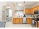 Spacious kitchen with stainless steel appliances, wooden cabinets, and an open layout at 10011 Tranquility Way, Tampa, FL 33625