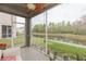 Relaxing screened-in lanai with view of the pond and features cozy patio furniture at 10011 Tranquility Way, Tampa, FL 33625