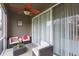 Cozy screened-in lanai features an outdoor ceiling fan and comfortable patio furniture at 10011 Tranquility Way, Tampa, FL 33625