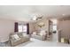 Cozy living room with wood floors, leather sofas, and a ceiling fan at 10011 Tranquility Way, Tampa, FL 33625