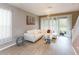 Bright living room features a modern chandelier, large windows and comfortable white couch at 10011 Tranquility Way, Tampa, FL 33625