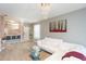 Open-concept living area showcases modern lighting, breakfast bar and comfortable white couch at 10011 Tranquility Way, Tampa, FL 33625