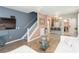 Open-concept living area features a tv, breakfast bar, staircase and comfortable white couch at 10011 Tranquility Way, Tampa, FL 33625