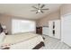 Large bedroom featuring a ceiling fan, wood-look floors, a window, and a large closet at 10011 Tranquility Way, Tampa, FL 33625