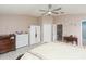 The bright primary bedroom is equipped with wood-look floors, a ceiling fan, and generous closet space at 10011 Tranquility Way, Tampa, FL 33625
