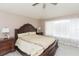 Spacious bedroom with wood-look floors, a ceiling fan, and a large window with natural light at 10011 Tranquility Way, Tampa, FL 33625