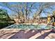 Backyard pool surrounded by a brick patio and wood fence at 10226 N Oakleaf Ave, Tampa, FL 33612