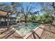 Backyard swimming pool surrounded by brick patio and screen enclosure at 10226 N Oakleaf Ave, Tampa, FL 33612