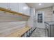 Laundry room featuring ample storage space with wood paneling and cabinets at 11112 Browning Rd, Lithia, FL 33547