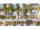 Aerial view of homes on a tree-lined street, some with pools and solar panels, providing a sense of neighborhood layout at 1218 74Th N St, St Petersburg, FL 33710