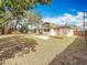 Large fenced backyard featuring a patio and wooden deck, perfect for entertaining and outdoor activities at 1218 74Th N St, St Petersburg, FL 33710