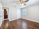 Bright bedroom features wood flooring, neutral walls, base molding, a ceiling fan and closet at 1218 74Th N St, St Petersburg, FL 33710