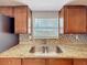 Kitchen detail showcasing a double stainless steel sink, window with blinds, and tiled backsplash at 1218 74Th N St, St Petersburg, FL 33710