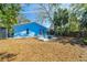 Backyard of this home featuring an outdoor seating area, fire pit, and storage shed at 1335 15Th St, Palm Harbor, FL 34683