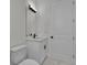 Elegant bathroom featuring a modern vanity with black hardware, a sleek mirror, and a toilet at 14207 Fort Worth Cir, Port Charlotte, FL 33981