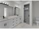 Bright bathroom featuring a double sink vanity, dark hardware, and a glass enclosed shower with marble tiling at 14207 Fort Worth Cir, Port Charlotte, FL 33981