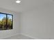 Bright bedroom featuring marble floors and a black framed window showcasing an outdoor view at 14207 Fort Worth Cir, Port Charlotte, FL 33981