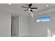 Bright bedroom with a modern ceiling fan, a long horizontal window, and neutral decor at 14207 Fort Worth Cir, Port Charlotte, FL 33981