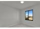 Bright bedroom with a black framed window showcasing an outdoor view and marble floors at 14207 Fort Worth Cir, Port Charlotte, FL 33981