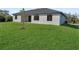 Lush, green lawn surrounds this modern one story home with black framed windows and ample space at 14207 Fort Worth Cir, Port Charlotte, FL 33981