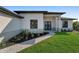 A landscaped walkway leads to the front door of this modern one-story home, complemented by fresh plantings at 14207 Fort Worth Cir, Port Charlotte, FL 33981