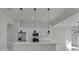 Sleek kitchen with white cabinetry, stainless steel appliances, an island, and pendant lighting at 14207 Fort Worth Cir, Port Charlotte, FL 33981