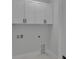 Bright laundry room featuring white cabinets and hookups for a washer and dryer at 14207 Fort Worth Cir, Port Charlotte, FL 33981