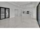 Bright living space featuring white marble floors, an open kitchen, and access to outdoor living via glass doors at 14207 Fort Worth Cir, Port Charlotte, FL 33981