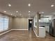 Inviting living room with wood flooring, neutral paint, and a view into the updated modern kitchen at 1511 Valencia St, Clearwater, FL 33756