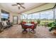 Screened patio featuring a brick floor, ceiling fan, and a table set with comfortable seating at 1727 Lakestone Dr, Trinity, FL 34655