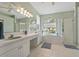 Bathroom featuring double sinks, a bathtub, and a glass-enclosed shower at 18521 Bittern Ave, Lutz, FL 33558