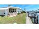 Backyard featuring a patio with outdoor seating, lush lawn, and canal access, perfect for waterfront living at 18675 Us Highway 19 N # 217, Clearwater, FL 33764