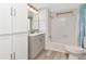 Bright and clean bathroom with white cabinets, modern fixtures, and a shower/tub combo at 18675 Us Highway 19 N # 217, Clearwater, FL 33764