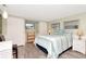 Cozy bedroom with a striped bedspread, two windows and light green walls at 18675 Us Highway 19 N # 217, Clearwater, FL 33764