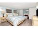Charming bedroom with a queen bed, light blue walls, and wood-look floors at 18675 Us Highway 19 N # 217, Clearwater, FL 33764